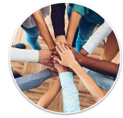 An image showing a diverse group of people putting their hands together in a circle.